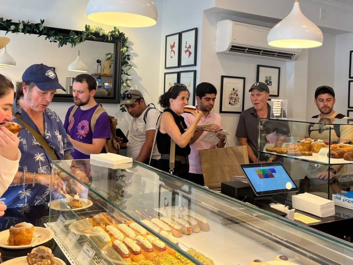 a group of people preparing food in a kitchen