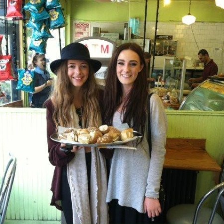a woman standing in front of a restaurant